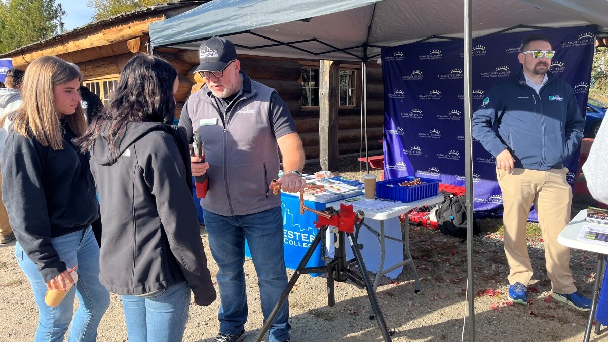 Representatives from Manchester Community College and Lakes Region Community College are talking to students.